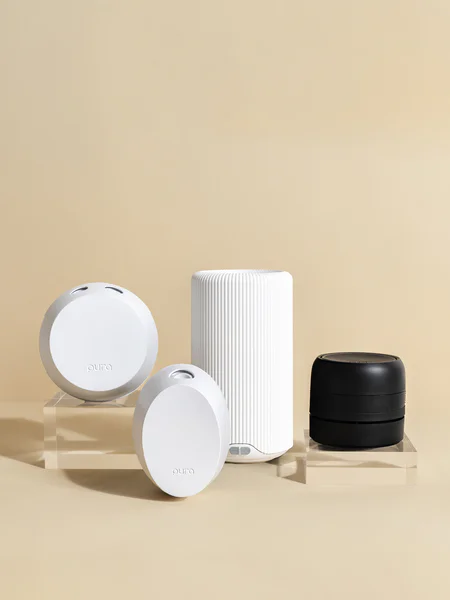 Various home fragrance devices displayed on a beige background.